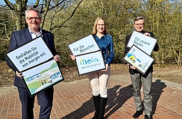 Winfried Wilkens, Anna Kebschull und Otto Steinkamp mit Plakaten zur Kampagne „Moin – Mobilität nachgefragt.“